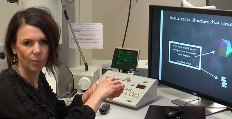 Visuel du SOT des vaccins contre les hépatites virales : chercheuse devant un TEM en train d'expliquer ce qu'est un virus